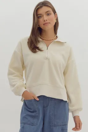  Solid long sleeve collared crop sweater featuring quarter zip detail.